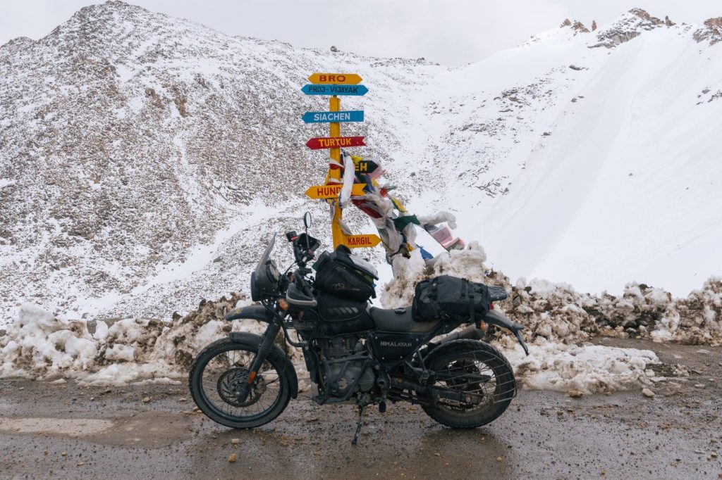 Snow-clad peaks, crisp air, and thrilling adventures like snow biking await at Khardung La Pass during winter.